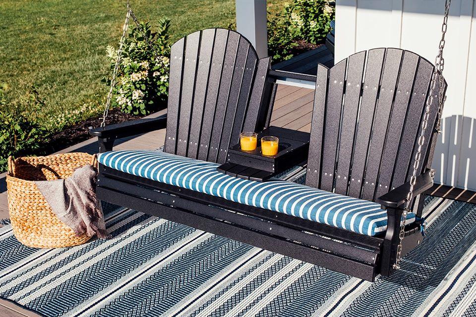 LuxCraft Adirondack recycled plastic porch swing on a front porch in fall
